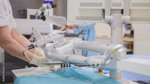 Surgeons and anesthesiologist prepare for surgery in an operating room - ophthalmology