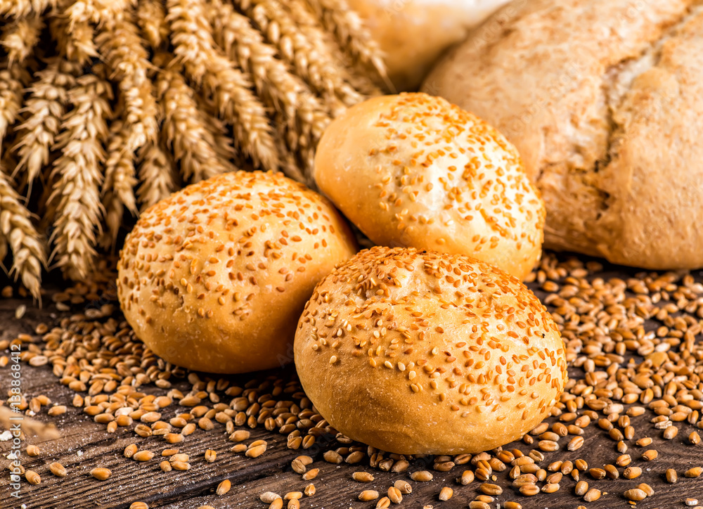 Assortment of baked bread on wooden table background Assortment of baked bread on wooden table background