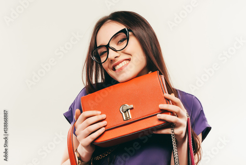 This fashionabe bag is my favorite. business woman in glasses. on a white background