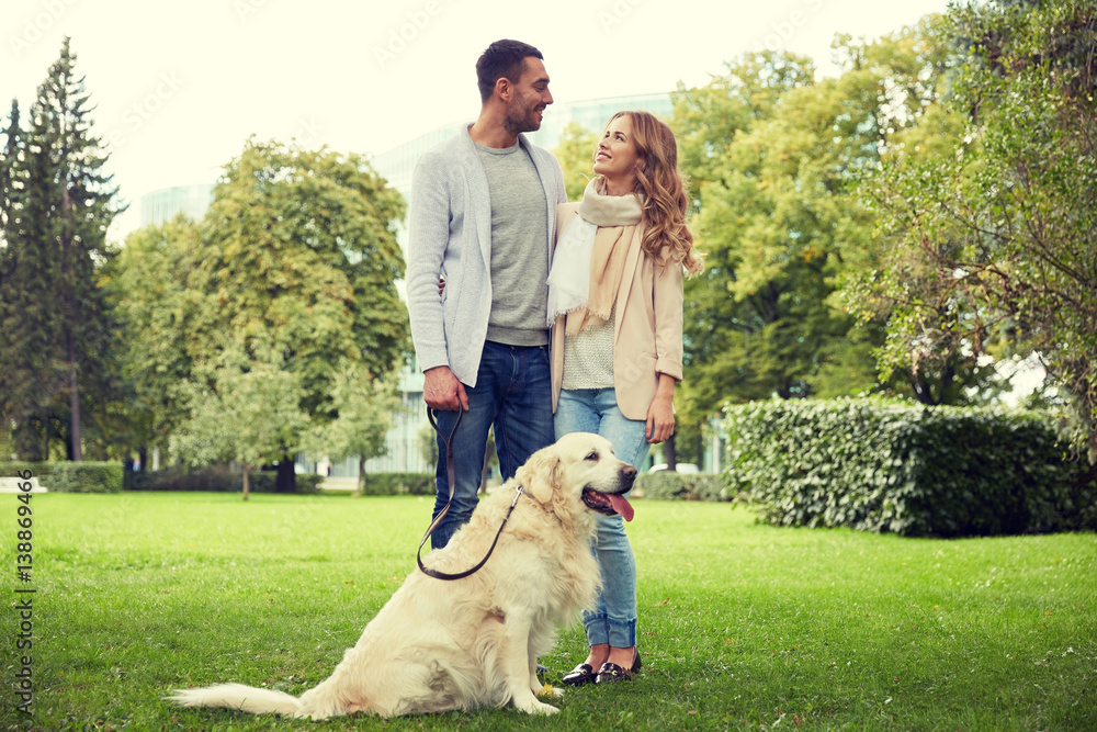 happy couple with labrador dog walking in city happy couple with labrador dog walking in city