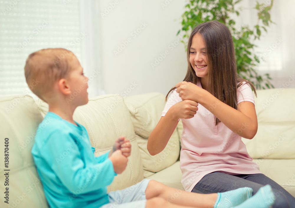 Brother and sister learn sign language at home. Deaf child Brother and sister learn sign language at home. Deaf child