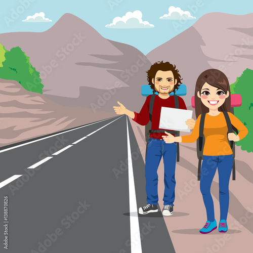 Couple with backpack hitchhiking standing on road side