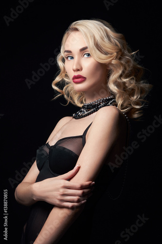 Sexy beautiful blonde girl with long hair. Perfect woman portrait on black background. Gorgeous hair and nice eyes. Natural beauty, clean skin, facial care and hair. Strong and thick hair. Jewelry