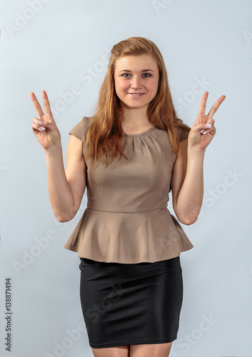 Cheerful young girl posing for the advertising