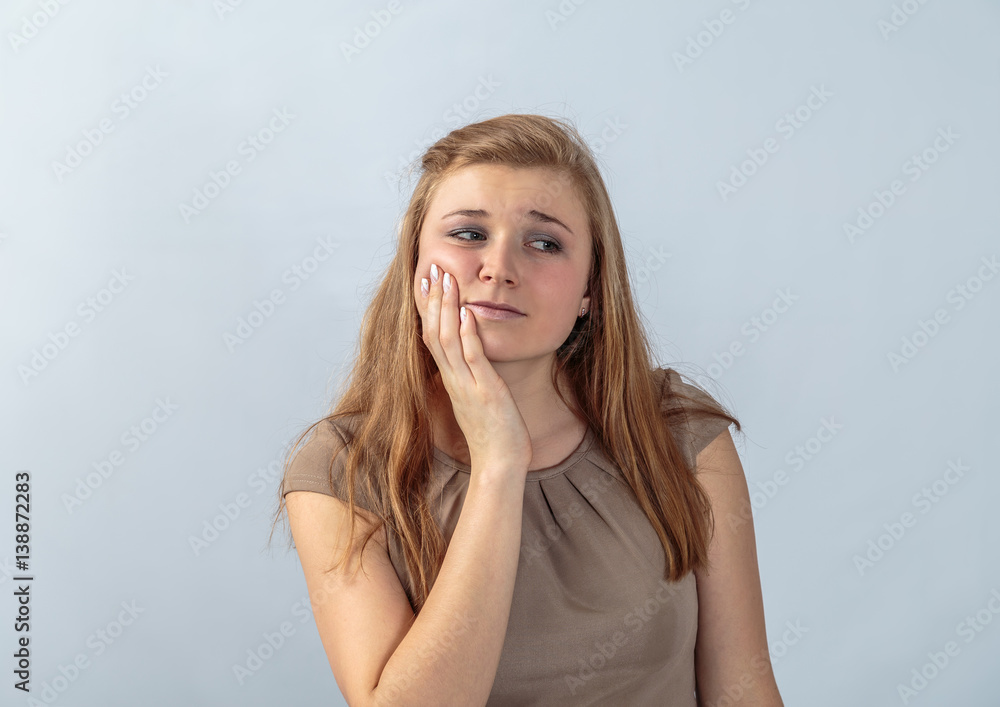 Fototapeta premium The girl at the age of 20 years is posing in a studio