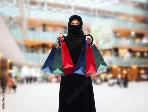 muslim woman in hijab with shopping bags