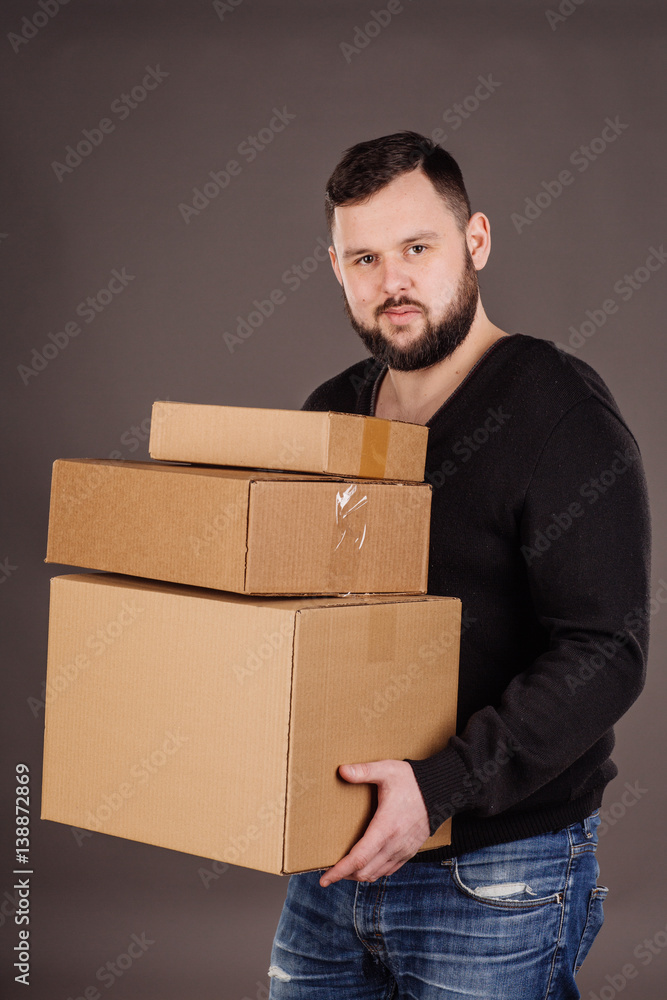 man holding pile of cardboard boxes in front man holding pile of cardboard boxes in front