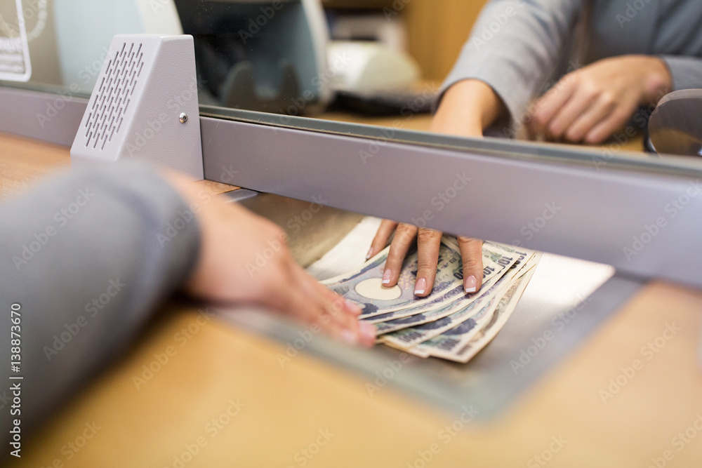 clerk giving cash money to customer at bank office StockFoto Adobe Stock