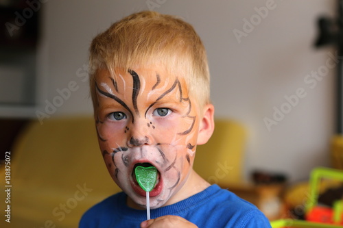 Boy with orange butterfly painted on the face photo