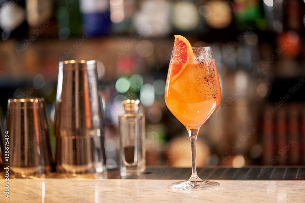 glass of grapefruit cocktail at bar glass of grapefruit cocktail at bar