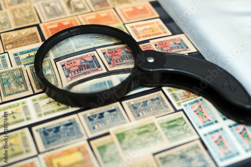 stamps of the Republic of Azerbaijan in the book under a magnifying glass