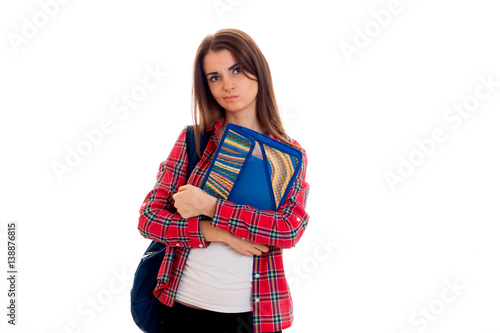 brooding teenage girl in Plaid Shirt looks to the side and holding a folder