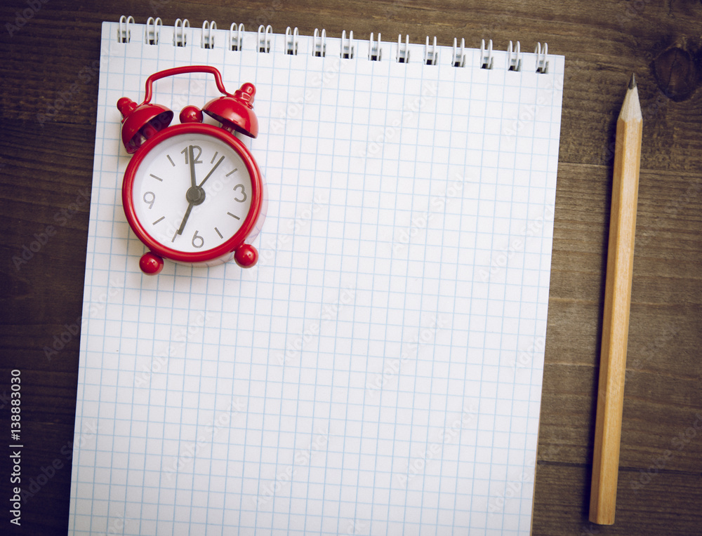alarm clock, notepad and pen
alarm clock, notepad and pen
