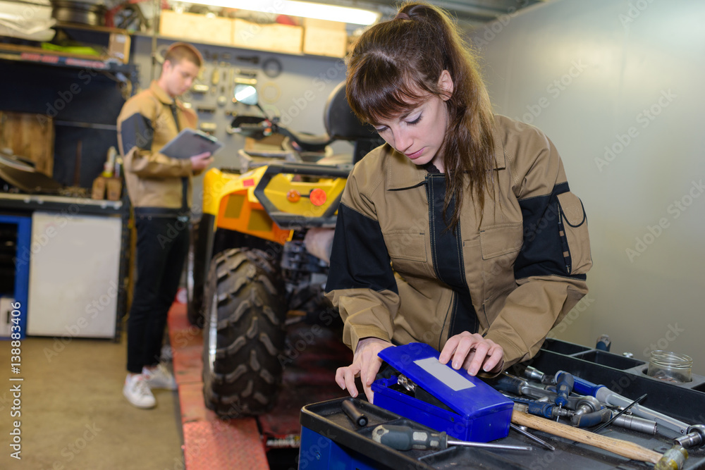 mechanic choosing tools to fix quad bike Stock Photo Adobe Stock