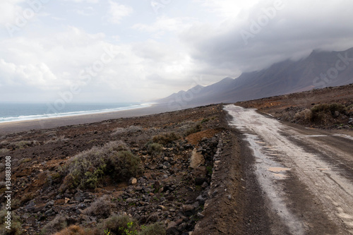 Road to Cofete Beach with mountains in the clouds - Jandia, Fuerteventura, Canary Islands, Spain