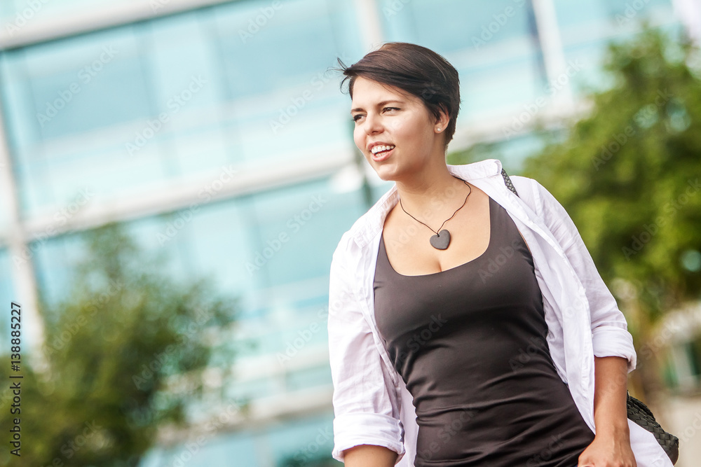 outdoor portrait of young happy smiling woman on urban city background outdoor portrait of young happy smiling woman on urban city background