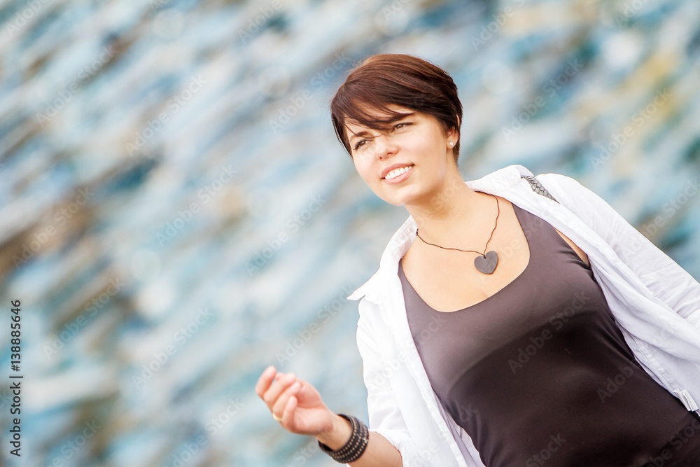 outdoor portrait of young happy smiling woman on urban city background outdoor portrait of young happy smiling woman on urban city background