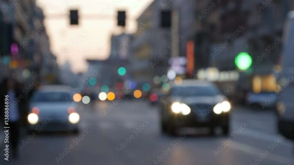 Cars and walking people on the street in the city at night with blurred background. Cars and walking people on the street in the city at night with blurred background.