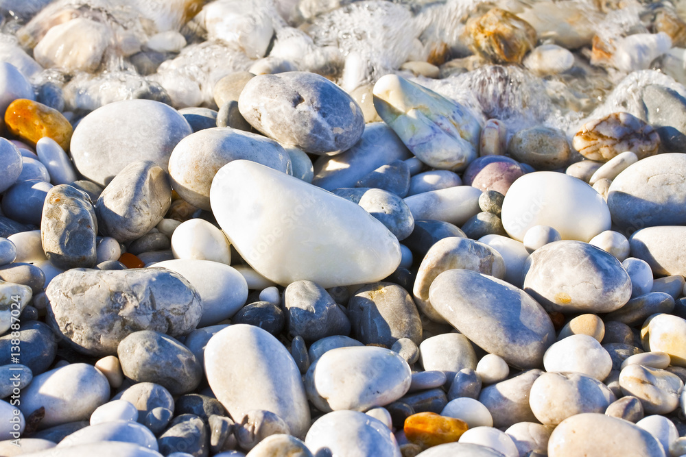 Background with white and gray stones softly rounded and washed from sea water Background with white and gray stones softly rounded and washed from sea water