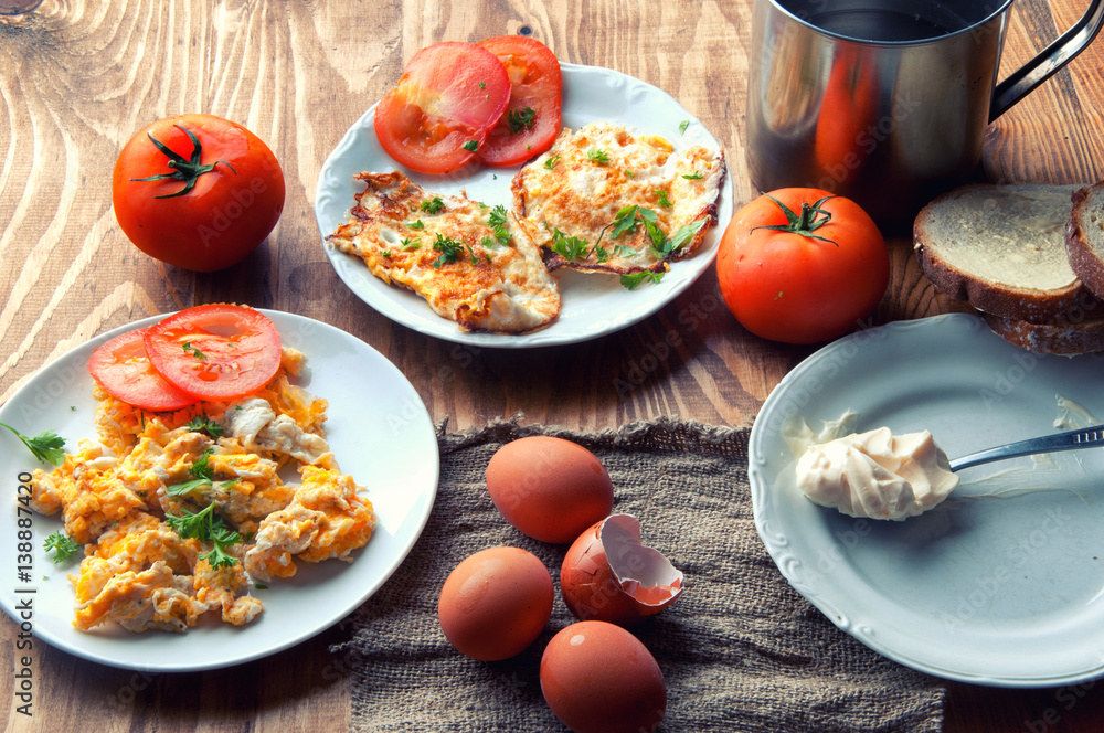 Scrambled, fried, boiled eggs on a wooden table Scrambled, fried, boiled eggs on a wooden table