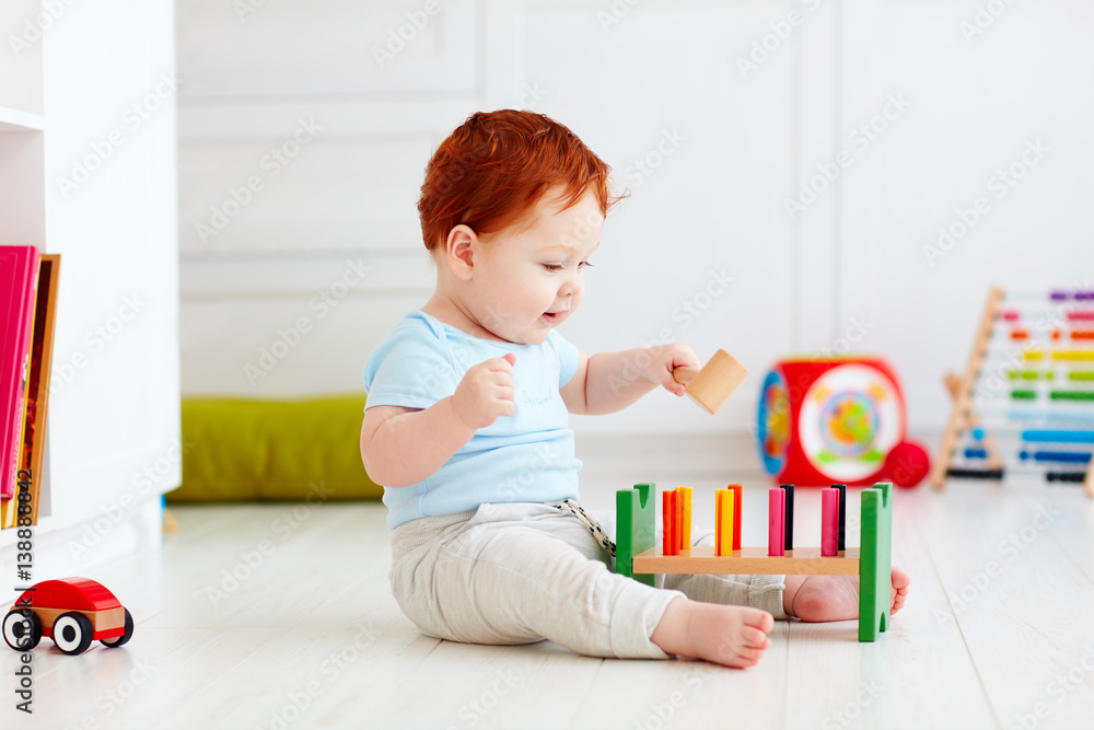 happy infant baby boy playing with toys at home happy infant baby boy playing with toys at home