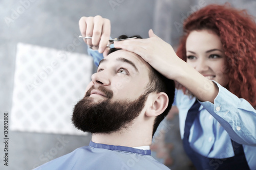 Handsome man visiting barber shop