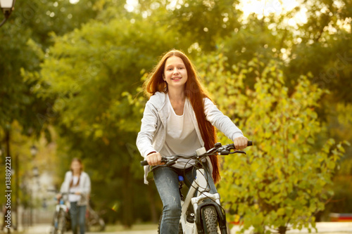 Cute girl riding bicycle in...