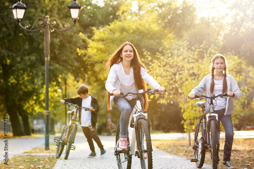 Cute girl riding bicycle in...