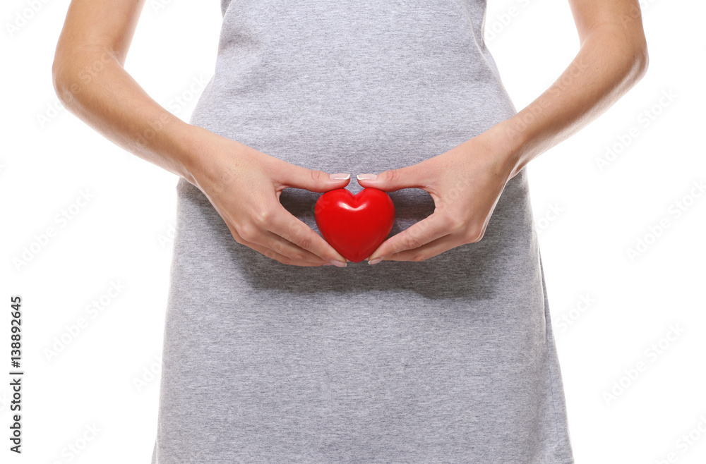 Close up view of woman with red heart on white background. Gynecology concept Close up view of woman with red heart on white background. Gynecology concept