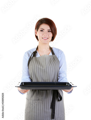 Young woman in apron holdin...