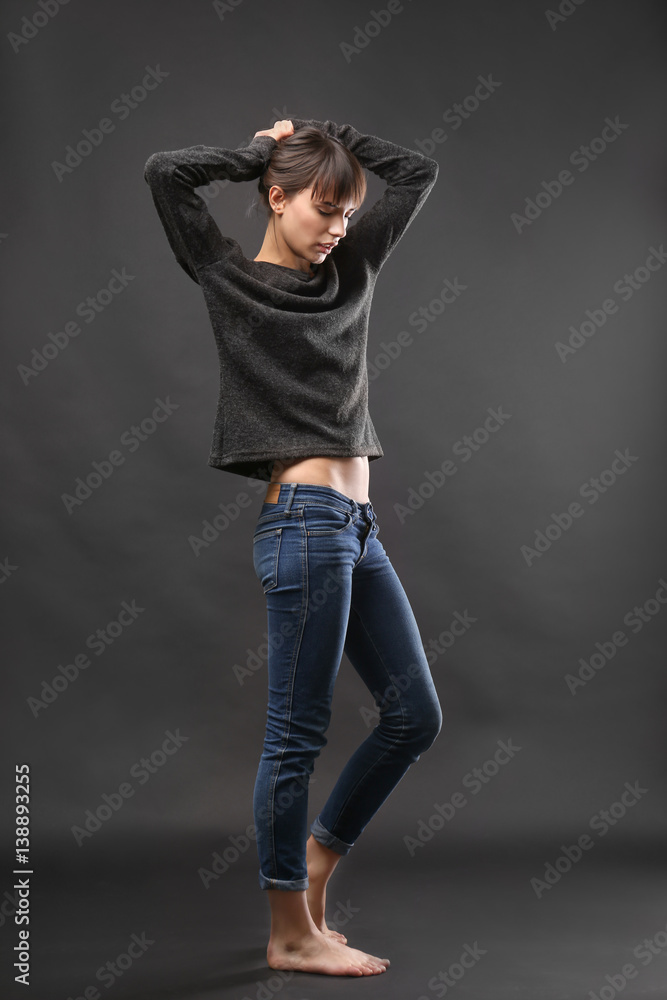 Beautiful young woman on dark background Beautiful young woman on dark background