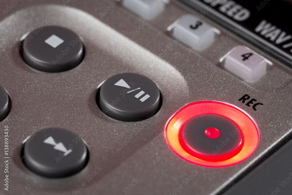 Red record button illuminated on recorder Red record button illuminated on recorder