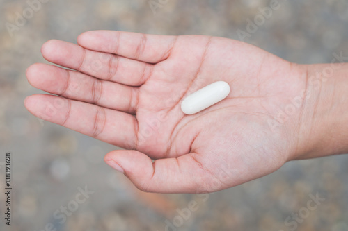 Medicine vitamin or capsules in hand, Medicine in palm © Bankerd