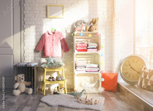Clothes on shelf in kids room