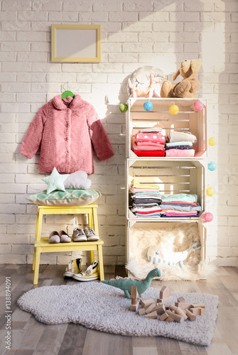 Clothes on shelf in kids room