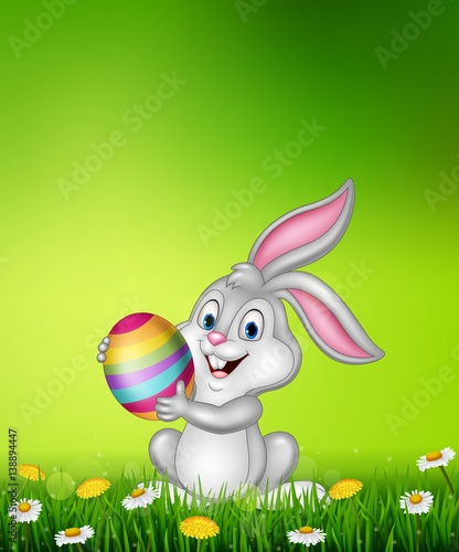 Cartoon little bunny holding Easter egg