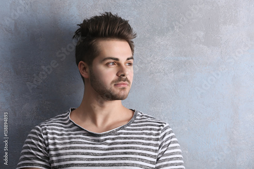 Handsome young man on color background © Africa Studio