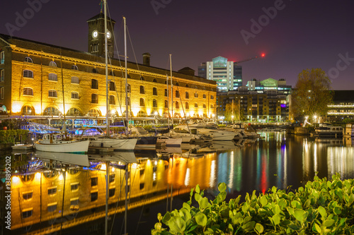 St Katharine dock in London at night, UK. Modern yacht and boat pier near Tower Bridge with view of Ivory House photo