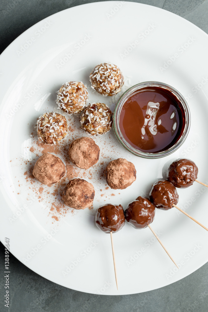 Protein Energy Balls and Melted Chocolate Dip on Plate Protein Energy Balls and Melted Chocolate Dip on Plate