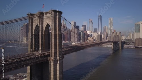 sunny flying left toward Brooklyn Bridge with downtown NYC skyline in background
