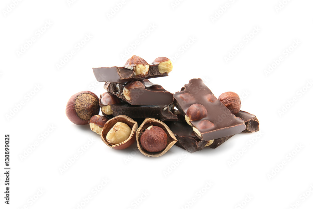 Broken chocolate pieces with nuts, isolated on white Broken chocolate pieces with nuts, isolated on white