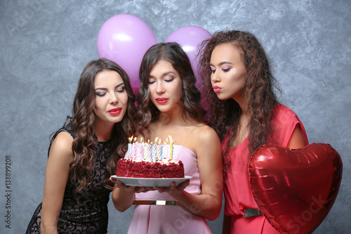 Beautiful young women blowi...