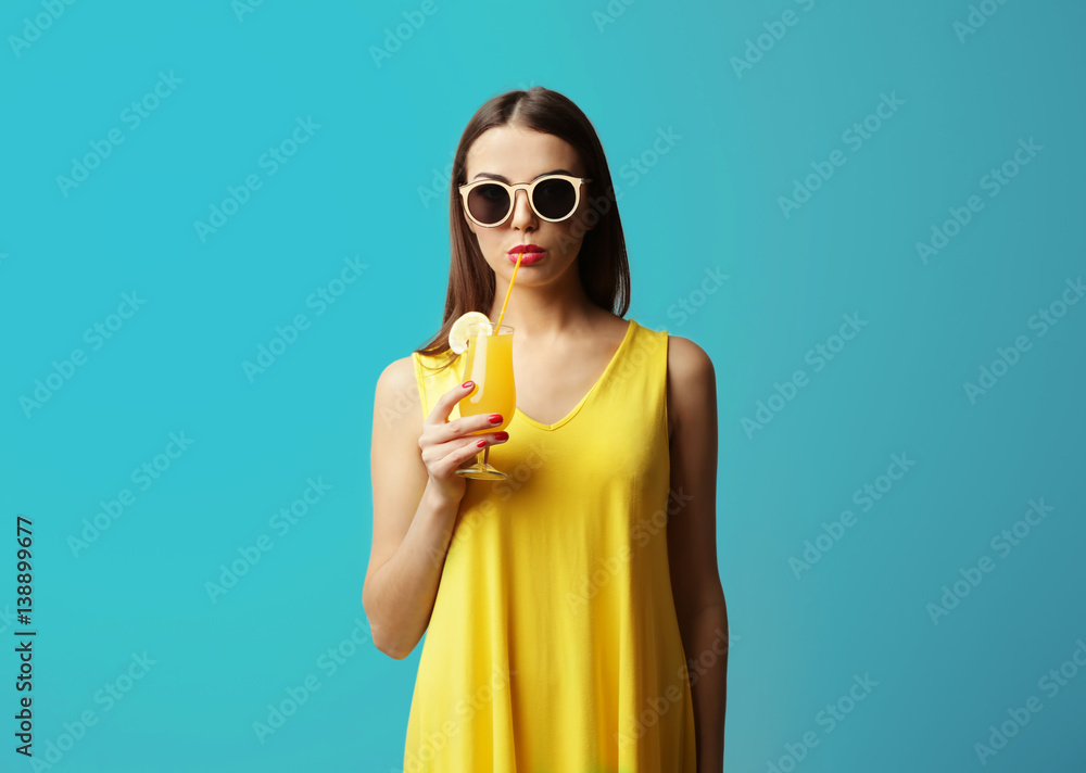 Young beautiful woman with tasty cocktail on light background Young beautiful woman with tasty cocktail on light background
