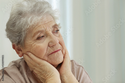 Depressed elderly woman at ...