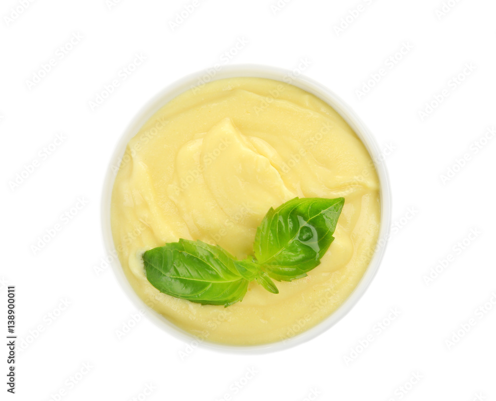 Creamy cheese and basil leaves in bowl, isolated on white Creamy cheese and basil leaves in bowl, isolated on white