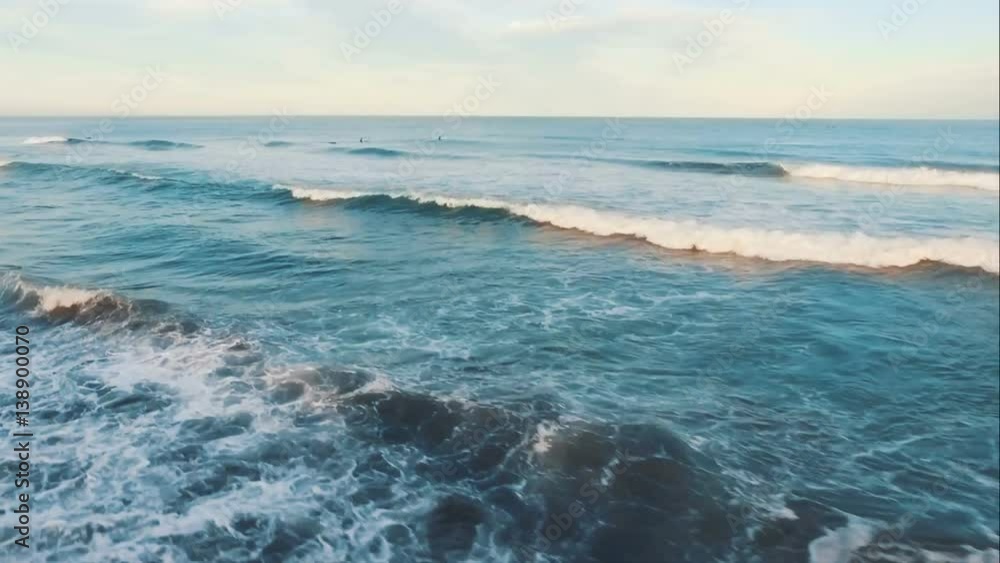 Aerial View. Surfers swim in the ocean at sunset. Aerial View. Surfers swim in the ocean at sunset.