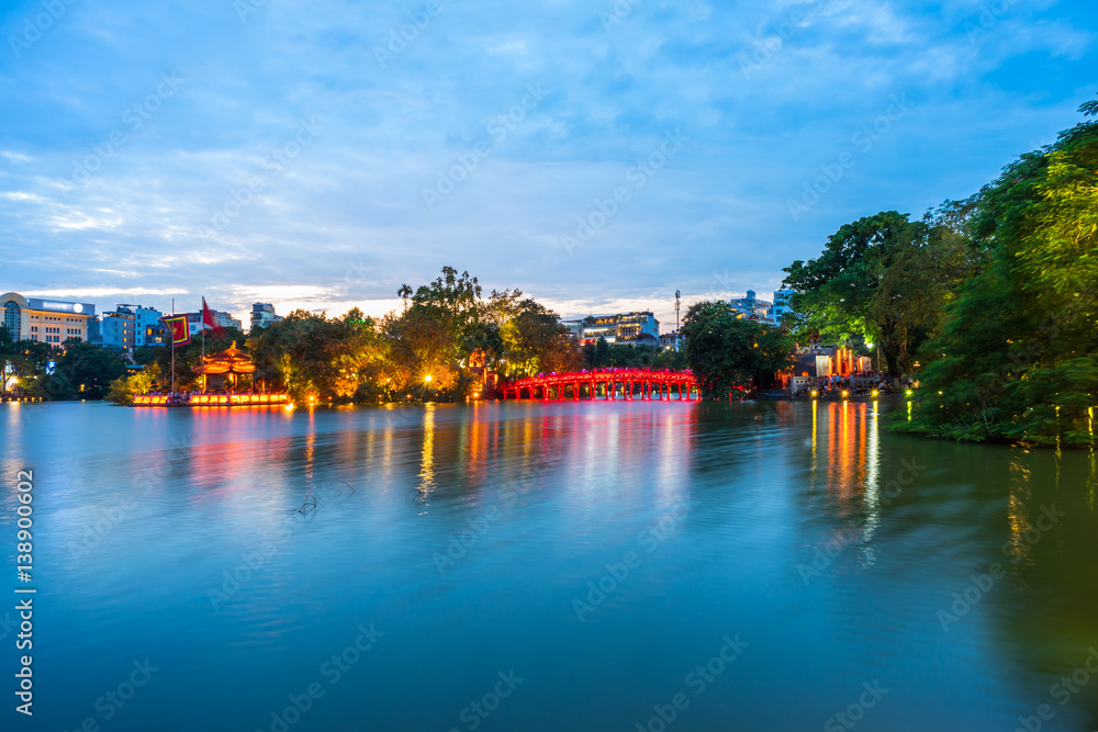 Hoan Kiem lake with The Huc bridge (red bridge) at twilight, center of Hanoi, Vietnam
