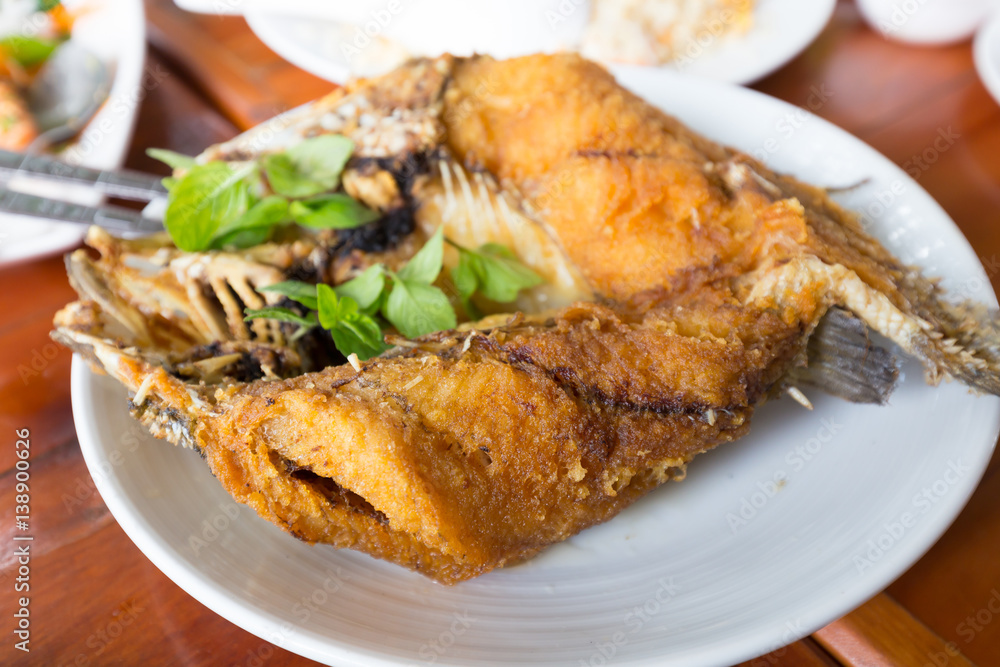 Deep fried snapper topped with sweet fish sauce with herbs Deep fried snapper topped with sweet fish sauce with herbs
