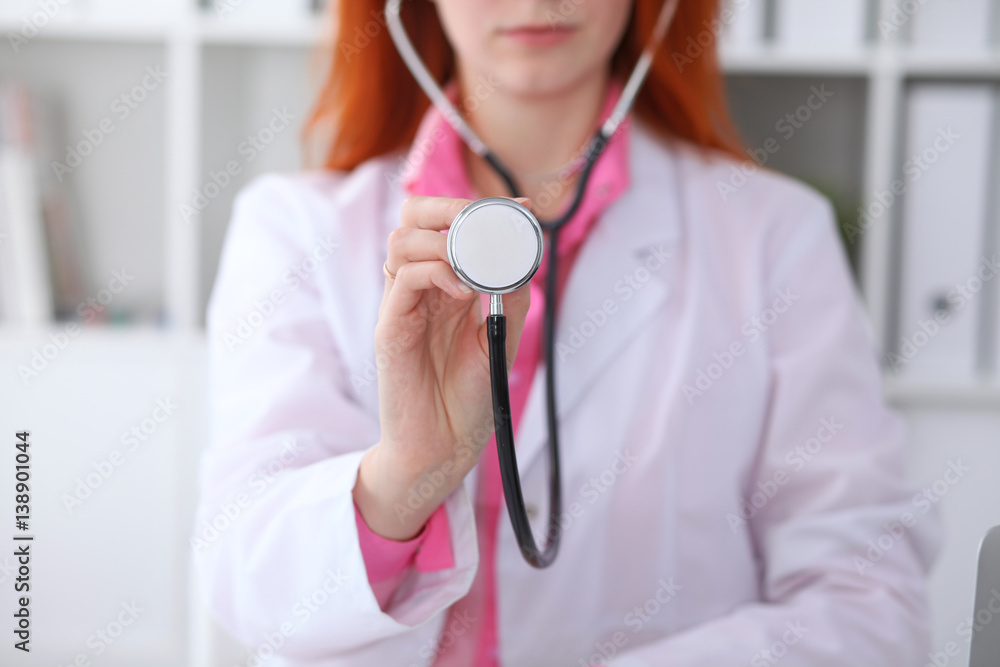 Doctor with a stethoscope in the hands. Pink colored scene Doctor with a stethoscope in the hands. Pink colored scene