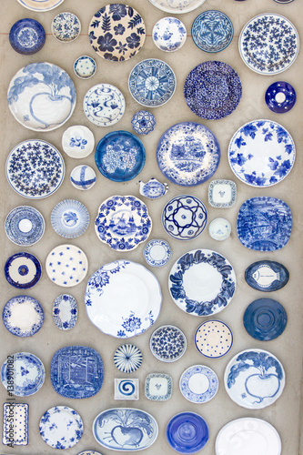 Porcelain plates placed on the cement floor for background.